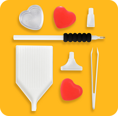 The diamond painting tool kit laid out: applicator pen, sorting tray, wax, tweezers